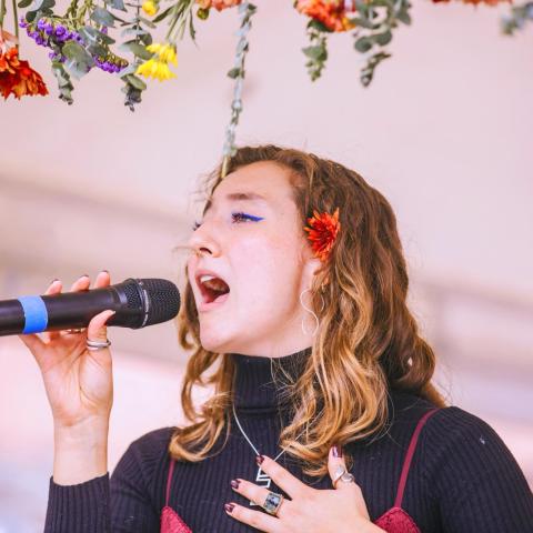 A woman singing into a microphone