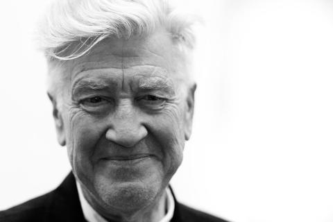 Close-up headshot of David Lynch against a blank background