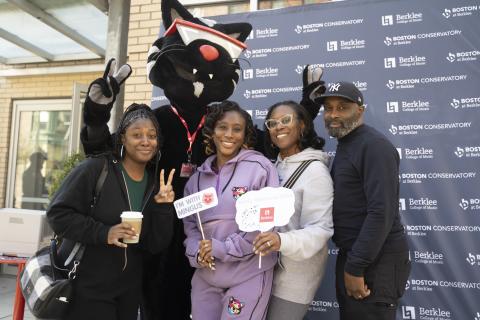 Mingus poses with students at Family Fest