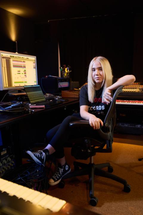 Suzy Shinn in her home studio surrounded by keyboards and a computer