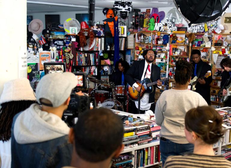 bartees strange performing with his band in an NPR office