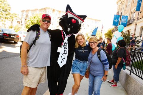 Family standing with Mingus the Jazz Cat