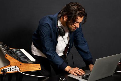 Berklee Online student uses his computer to create music