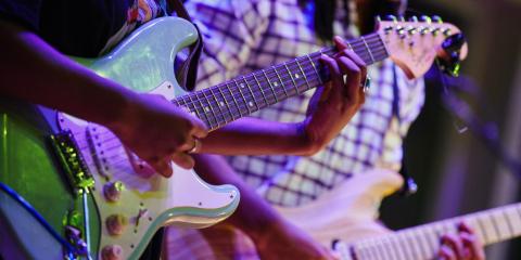 Photo of guitarists performing 