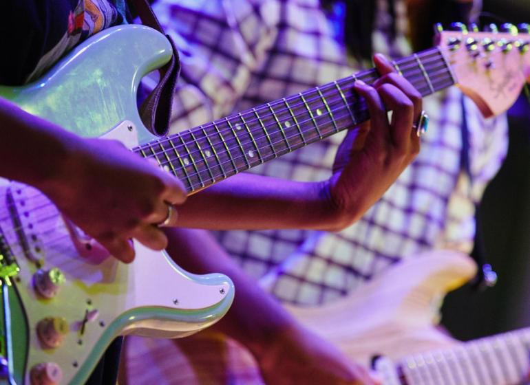 Photo of guitarists performing 