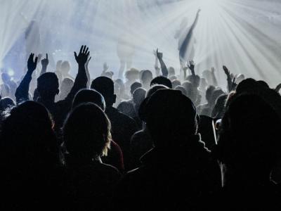 people at a concert facing a stage