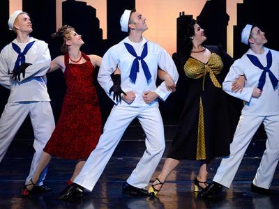 Actors on stage in 1940s attire