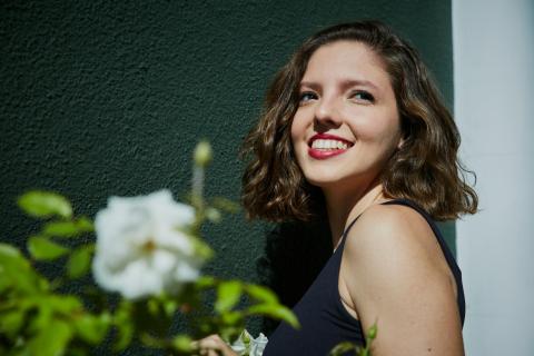 Esin Aydingoz standing next to flowers