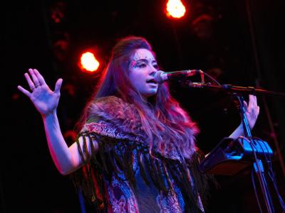 Vocalist performing in stage costume and makeup