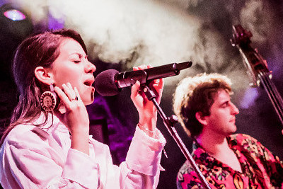 Two performers on stage with dramatic lighting