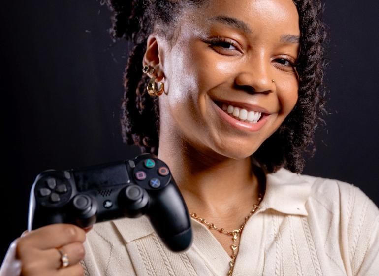Rachel McFarlane holding a Playstation controller