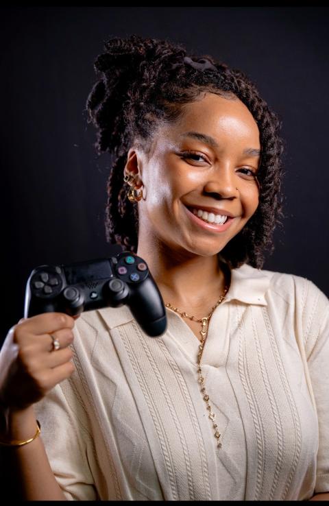 Rachel McFarlane holding a Playstation controller