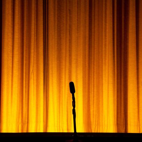 stage with yellow curtain and microphone
