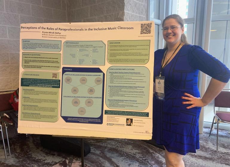 Krysta Mirsik DePuy poses with her thesis.