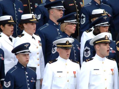 Chorus in formal military attire singing