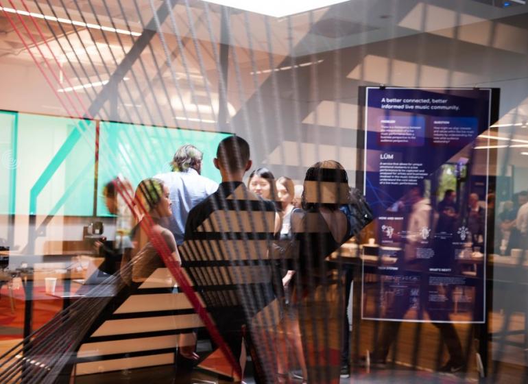 Students conversing at a music business seminar