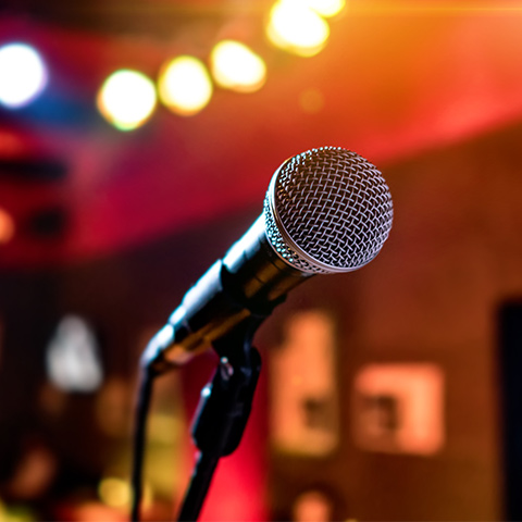 microphone on a stage with lights behind it 