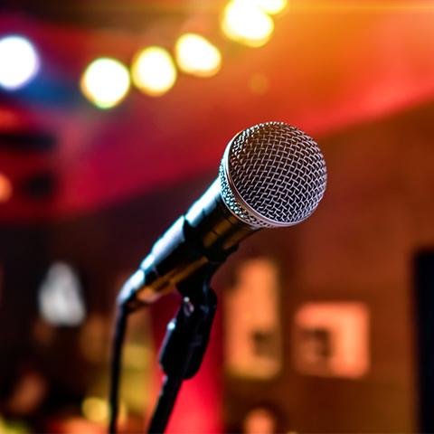 microphone on a stage with lights behind it 