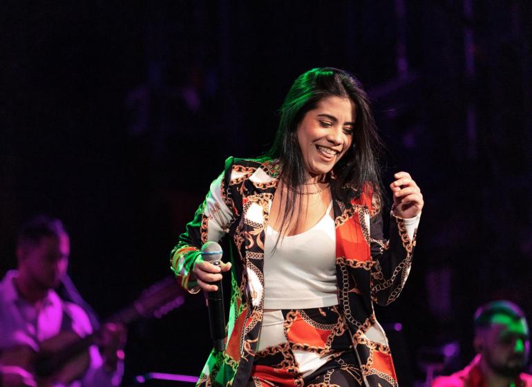 A woman vocalist dancing on stage