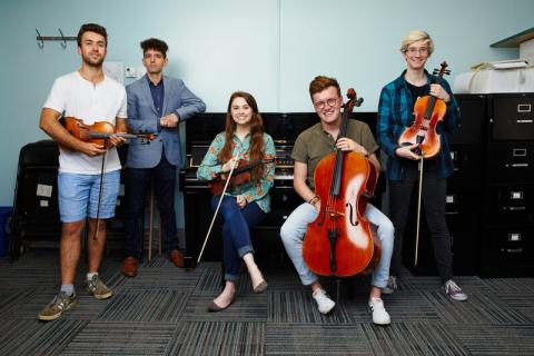students posing with instruments