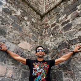 Antonio Sánchez in the corner of a cobblestone wall