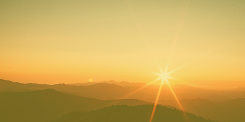 Sunrise over the mountains with a yellow layered filtered