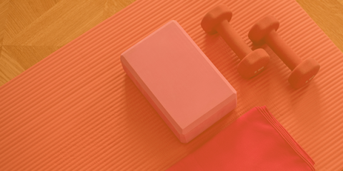 Yoga block and weights on a yoga mat